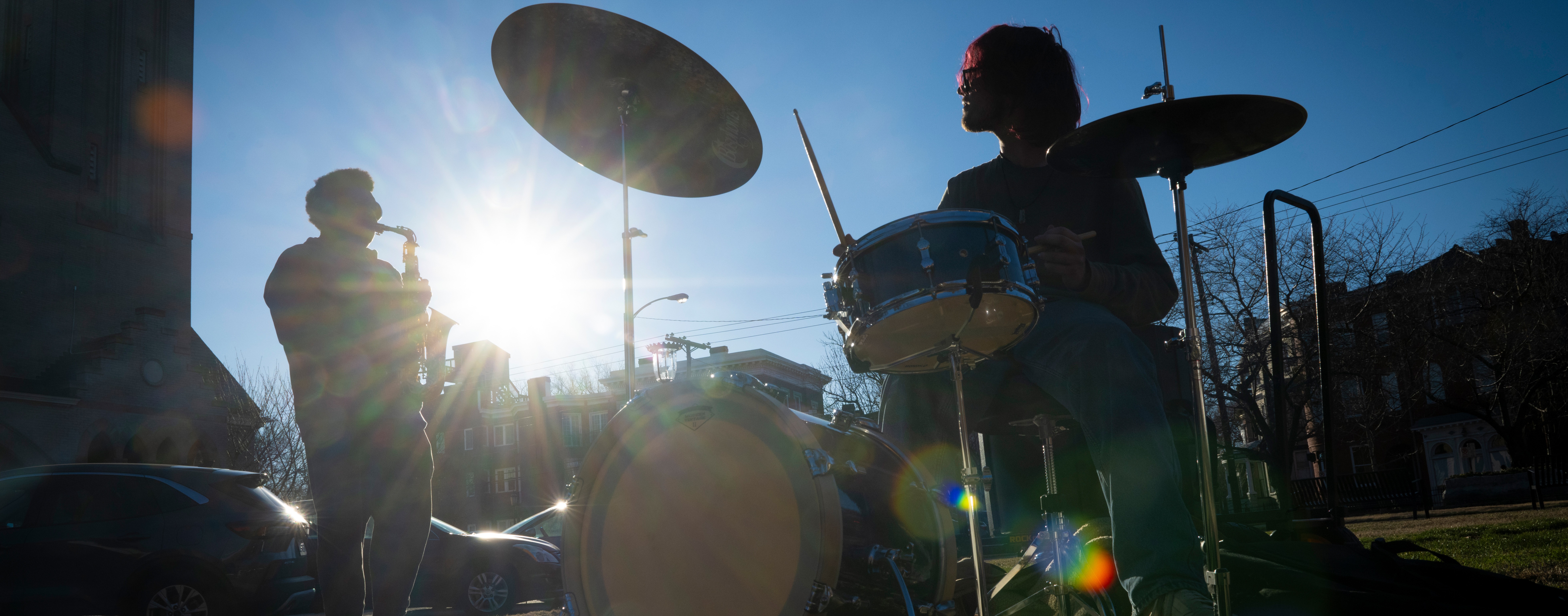 Students playing instruments outside on campus